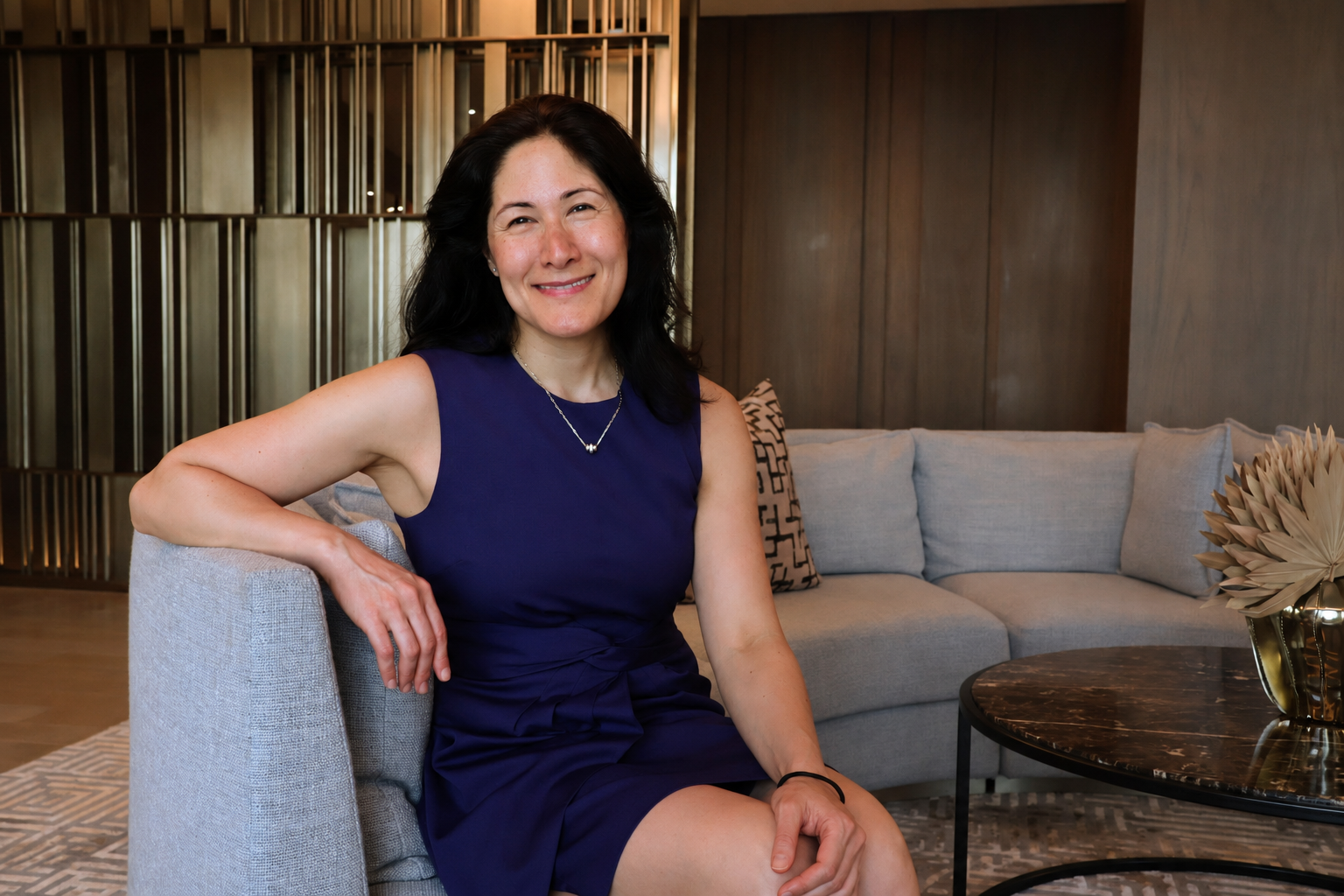 Dr. Alexandra Channing seated in a modern clinical office.